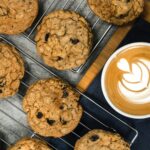 Indulge in homemade oatmeal cookies paired perfectly with a latte featuring beautiful latte art.